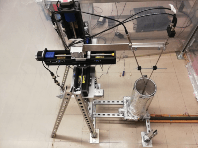 An image of the coaxial jet inside of the enclosure, with the tri-axial traversing motor.